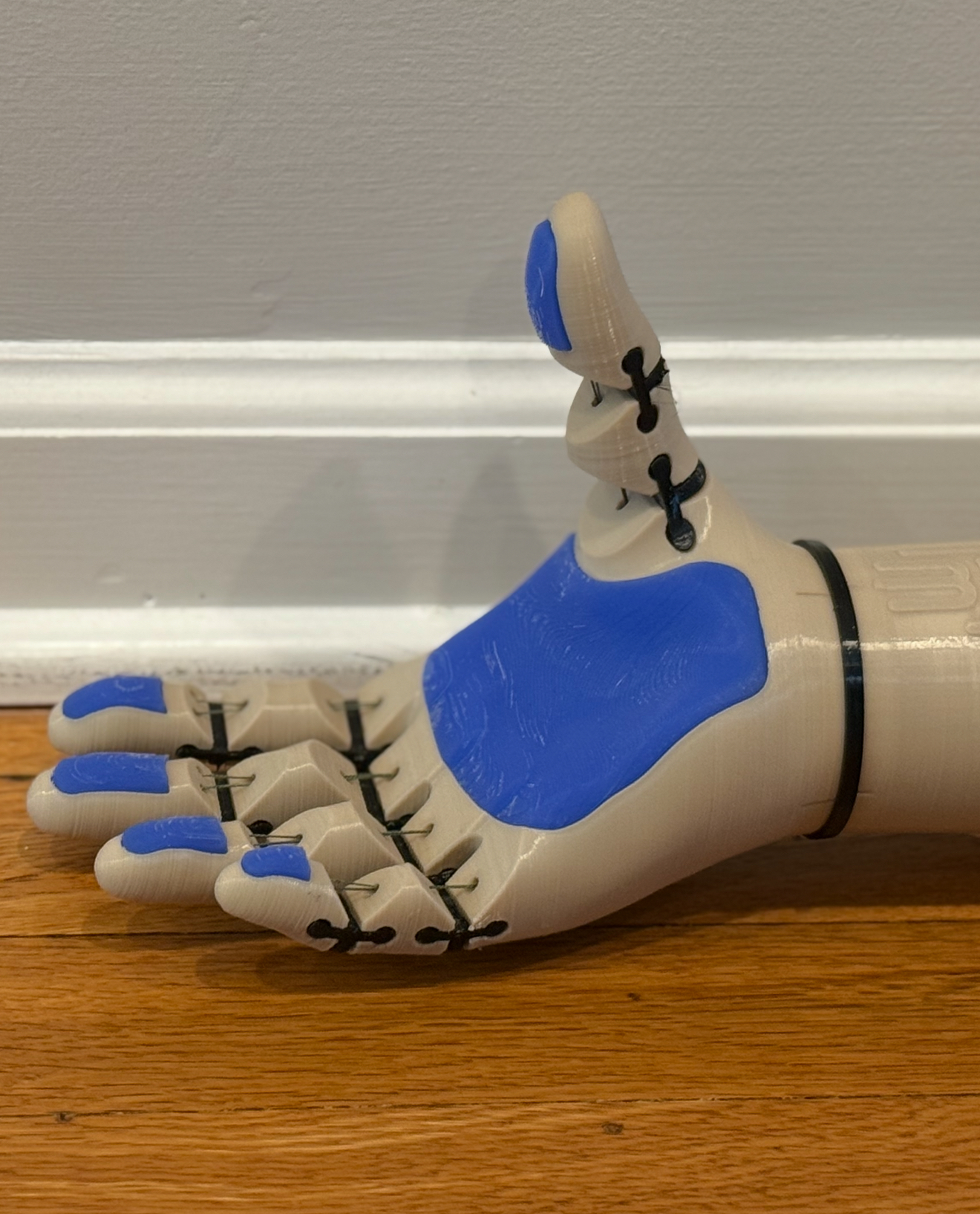Palm detail, blue TPU pads, thumb up, finger mechanism
