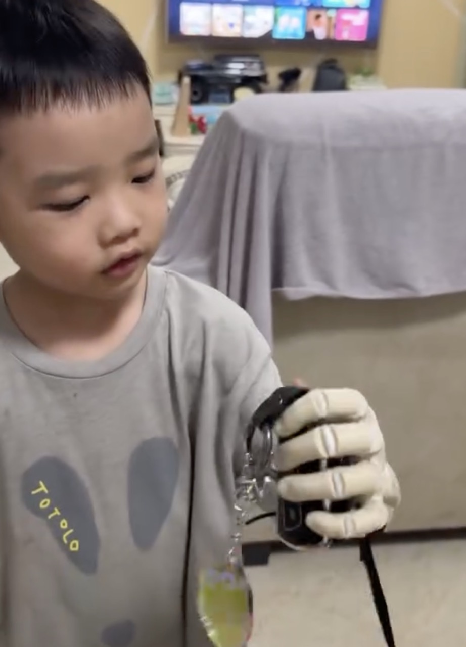 W. holding his keychain, hand gripping the keys