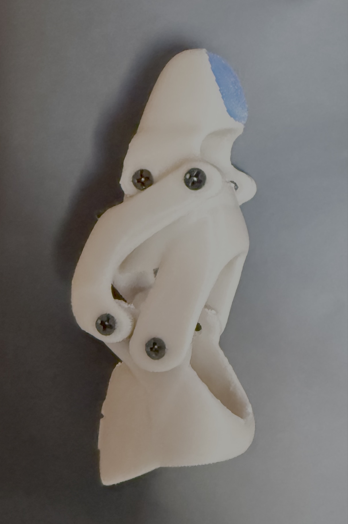 Side profile of the finished prosthetic in the bent position, showing the hinge mechanism