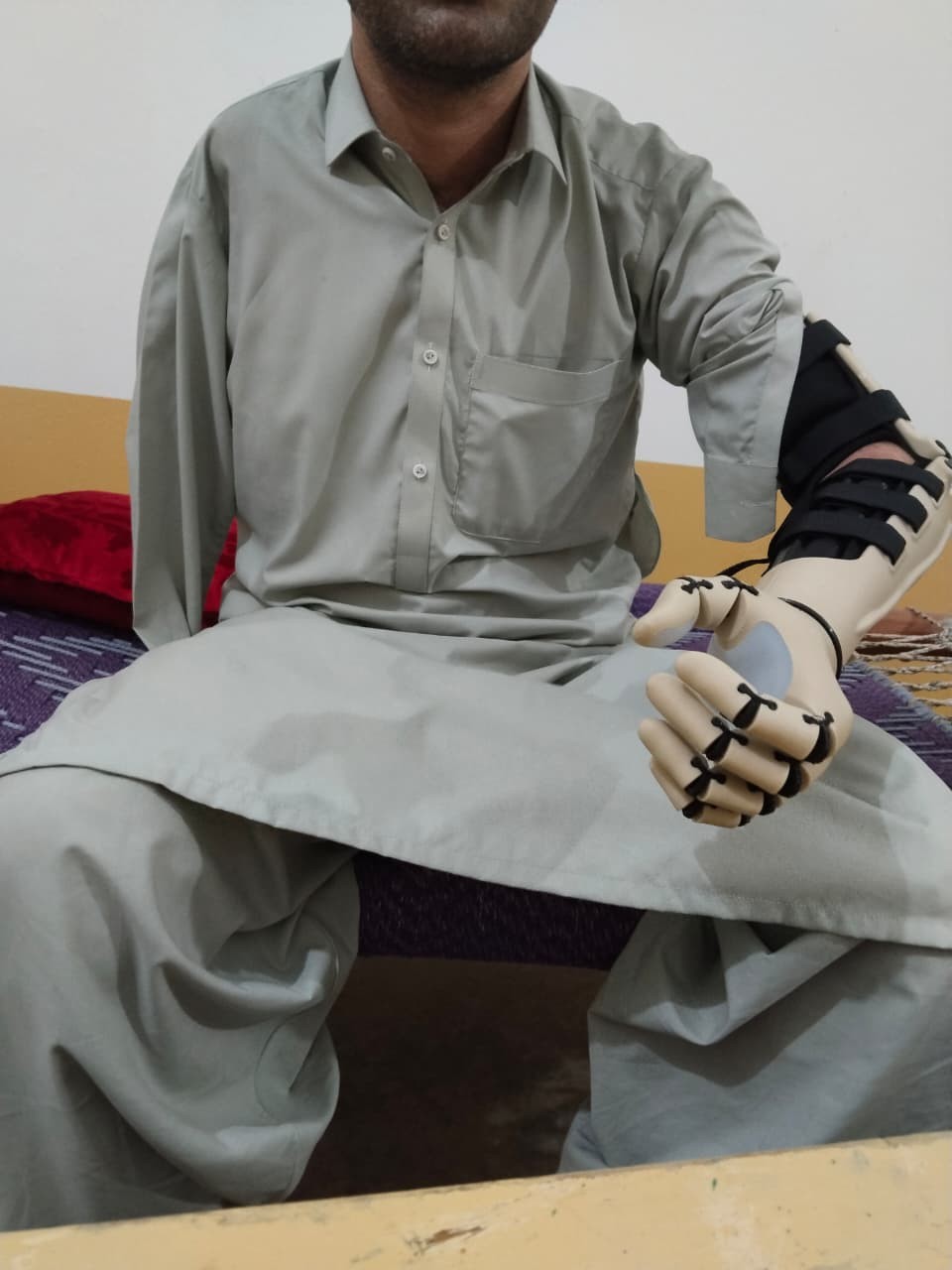 A.S. seated, Kinetic Arm showing fingers in gripping position