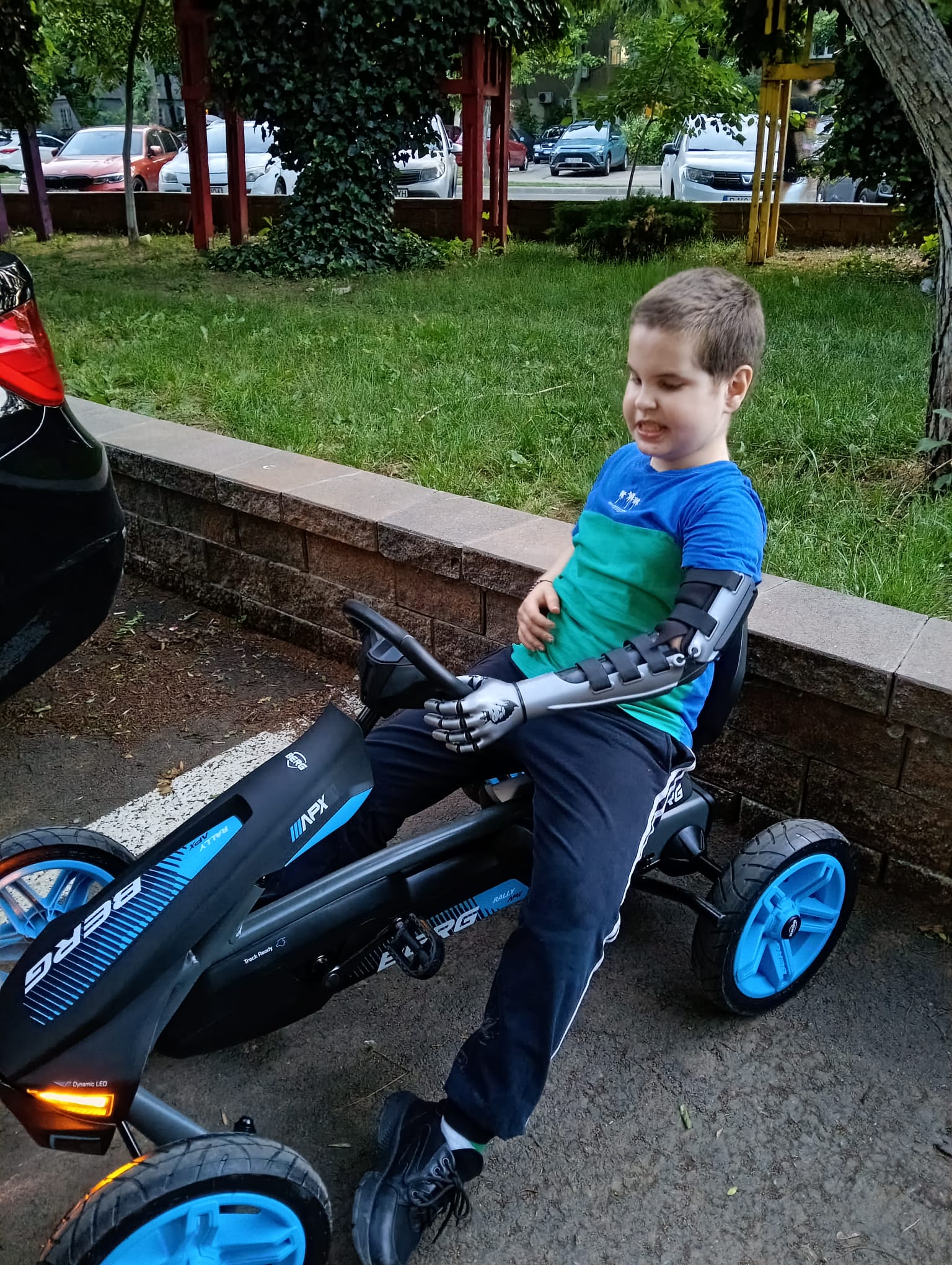 A. in his BERG go-kart from a closer angle, the crowned lion visible on the arm