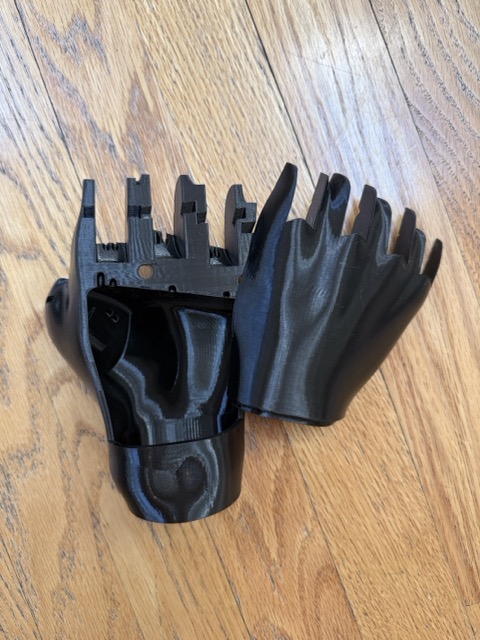 3D printed palm components of the El Medallo Bionic Arm, showing the hollow interior where electronics will be housed