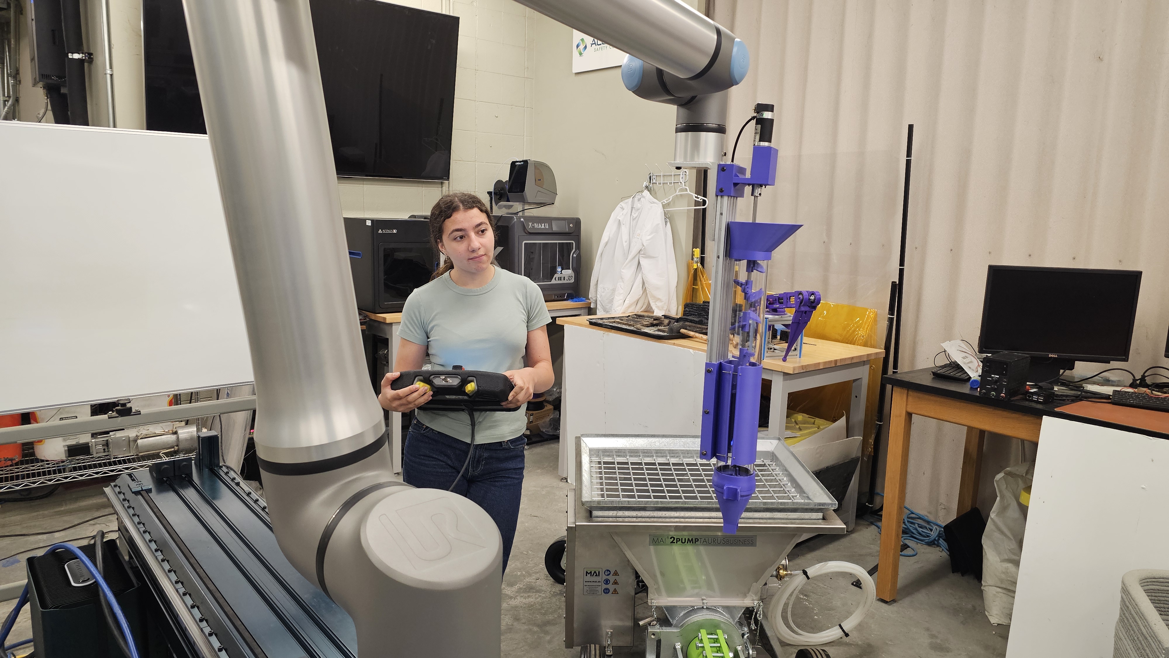 Laila operating the UR robot with a handheld controller in the RECAST Lab at LSU