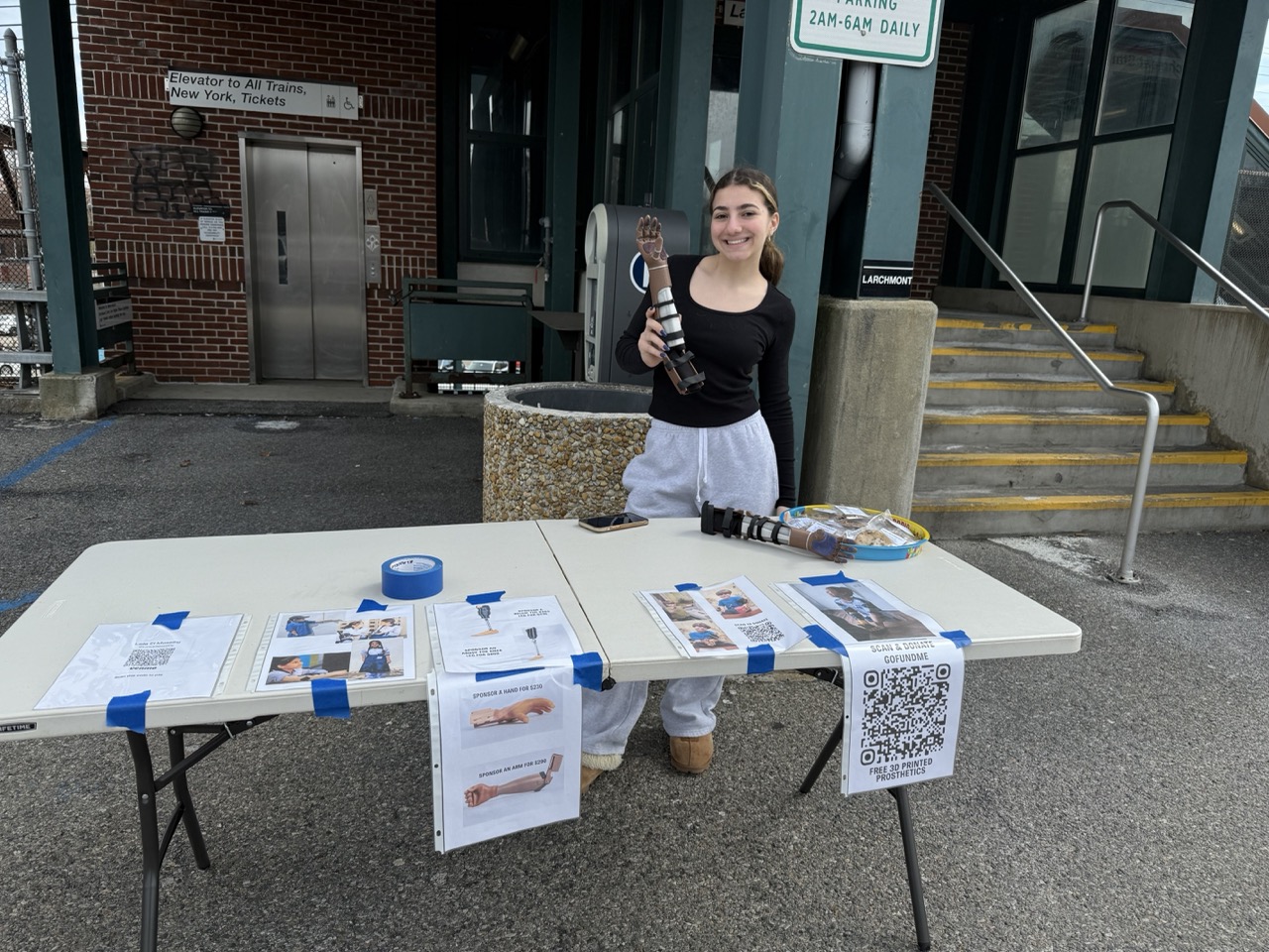 Laila at her fundraising table at Larchmont train station